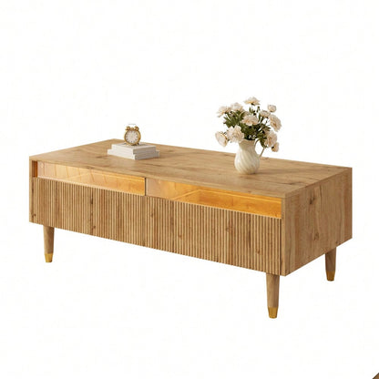 Dieser moderne LED-Couchtisch verfügt über eine gewellte Schubladenplatte, gold-holzfarbene Beine, zwei Schubladen und einen farbwechselnden LED-Lichtstreifen