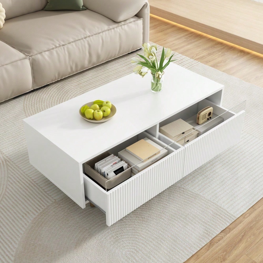 Dieser moderne LED-Couchtisch verfügt über eine gewellte Schubladenplatte, gold-weiße Beine, zwei Schubladen und einen farbwechselnden LED-Lichtstreifen. Ein passender TV-Schrank ist ebenfalls erhältl